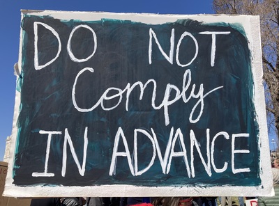 Hand painted sign that says Do Not Comply In Advance